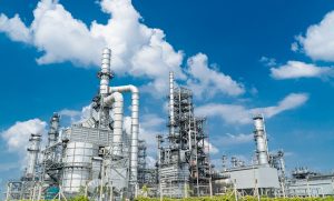Oil and gas industrial,Oil refinery plant form industry,Refinery factory oil storage tank and pipeline steel blue sky background