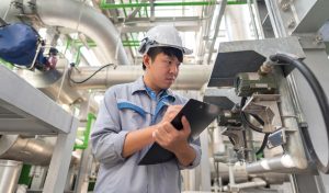 Engineer working and check valve at a a water treatment plant