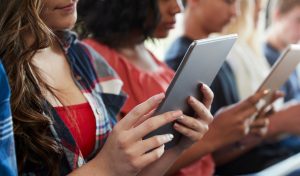 Close Up Of A Line Of College Students Using Digital Tablets