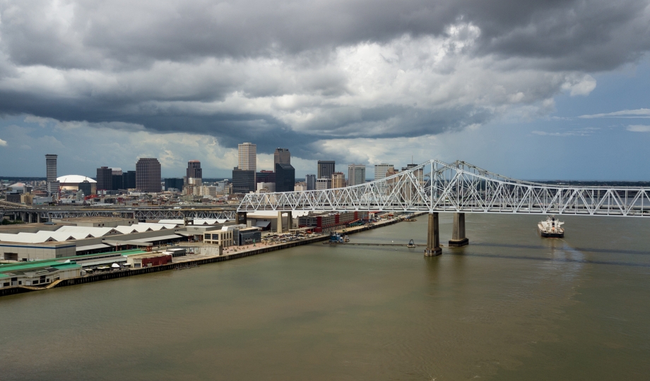 The Mississippi River flows softly past the downtown city skyline waterfront of a Louisiana city