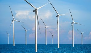 Wind turbine farm power generator in beautiful nature landscape for production of renewable green energy is friendly industry to environment. Concept of sustainable development technology.
