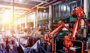 Large factory robot is operating an assembly line job