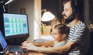 multi-tasking, freelance and fatherhood concept - student father with baby daughter and laptop computer at home 