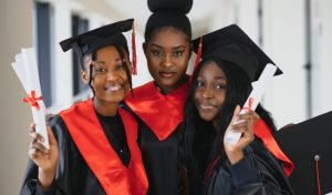 portrait of multiracial graduates holding diploma