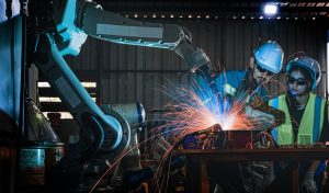 factory engineers using smart control to control the arm robot machine for cutting the metal sheet. specialist Worker working at height technology industry for produce the electronic part device.