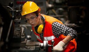 Female Engineer staff operating a cnc machine in factory