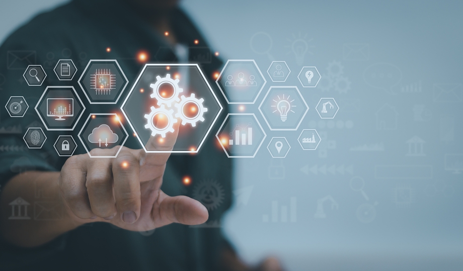 Man's hand touching cogwheel icon, automation technology concept, data analysis, processing, efficiency and productivity in business and industrial workflows.