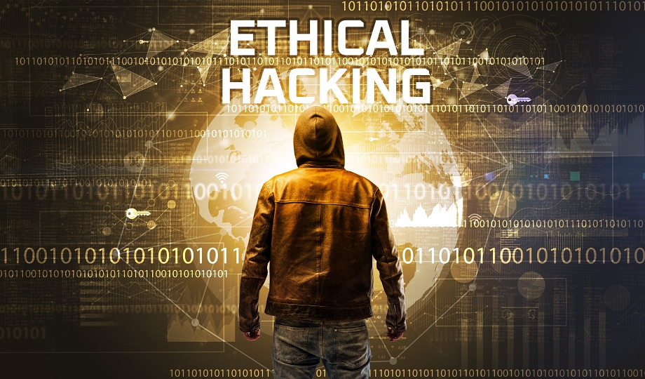 Faceless hacker at work with ETHICAL HACKING inscription, Computer security concept