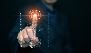 Digital twin concept. Industrial manufacturing automation technology. A man uses virtual icons of digital twin system to control both physical and digital counterparts