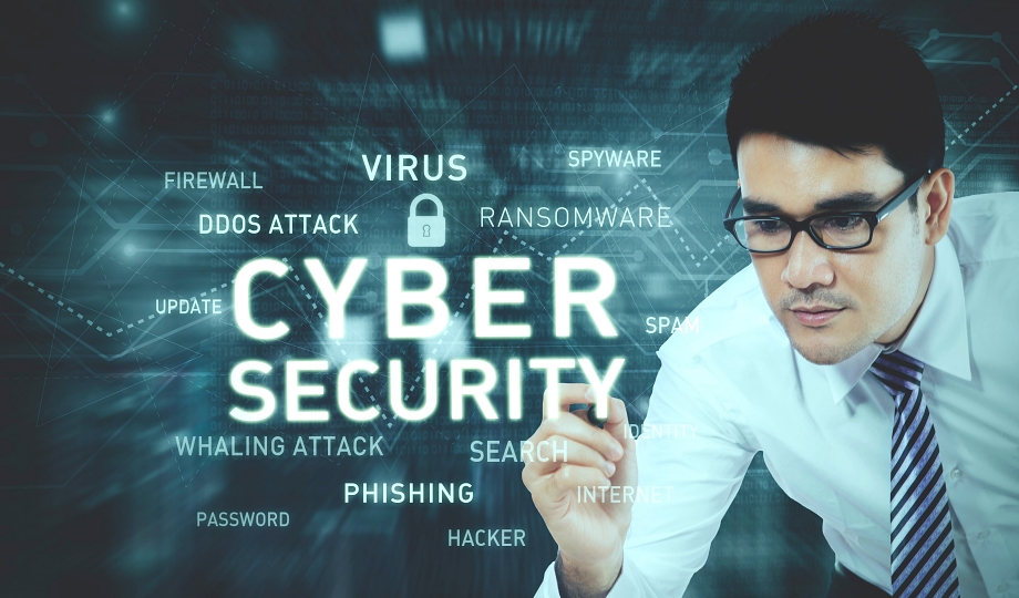 Picture of young businessman wearing glasses while writing a text of cyber security on the virtual screen