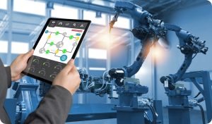 Engineer hand using tablet, heavy automation robot arm machine in smart factory industrial with tablet real time process control monitoring system application. Industry 4th iot concept.