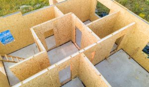 Construction of new and modern modular house. Walls made from composite wooden sip panels with styrofoam insulation inside. Building new frame of energy efficient home concept.