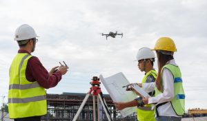 Construction concept , Engineer and Architect working with drone for inspection over construction site.