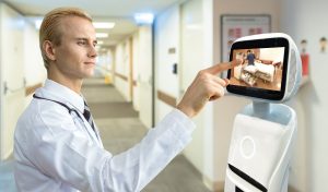 Doctor using a hospital service robot's touchscreen to check on a patient room