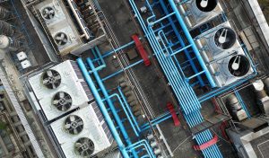 Aerial drone view of rooftop HVAC units and piping during an inspection