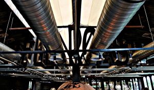 Large industrial ductwork installed above a warehouse distribution facility