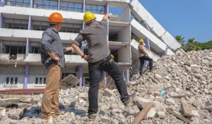 Construction managers assessing storm damage to a residential building