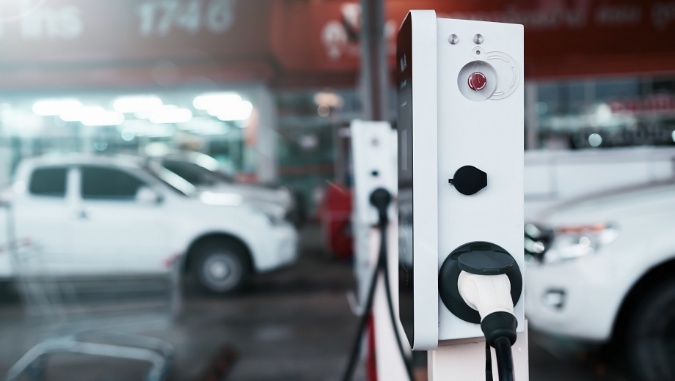 Electric vehicle charging station inside a modern automotive service facility.
