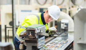 Process technician troubleshooting equipment at a paper mill
