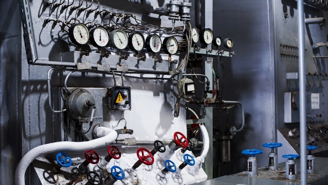 Industrial instrumentation equipment with pressure gauges, pipes, and control valves.