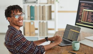IT support specialist working on a laptop in a help desk technician career path