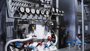 Panel of pressure gauges and valves used by an instrument calibration technician in an industrial instrument room