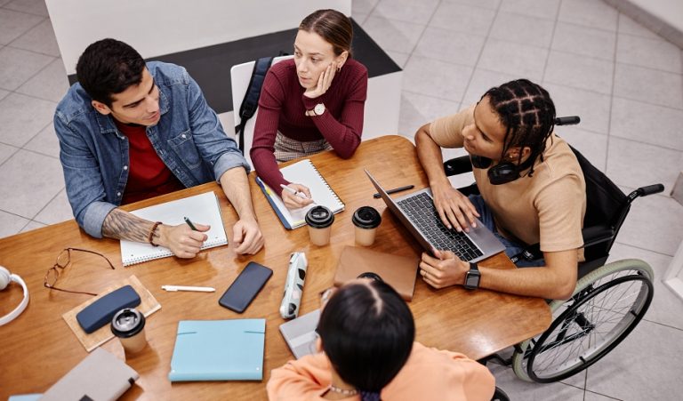 Students studying together while deciding between trade school or community college