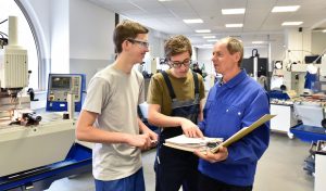 Trade school students learning hands-on technical skills in a lab